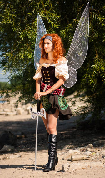 Cosplayer Grusli posing as the Pirate Fairy from Tinkerbell with fabric fairy wings
