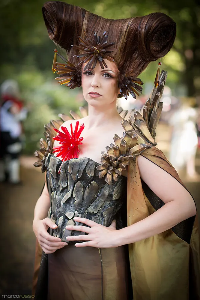 Me posing as "The Earthy from Card Captor Sakura", a woman with a brown high up styled wig that has a ton of crystals attached to it. I'm wearing a corset that resembles a rock and a collar that resembles crystals.